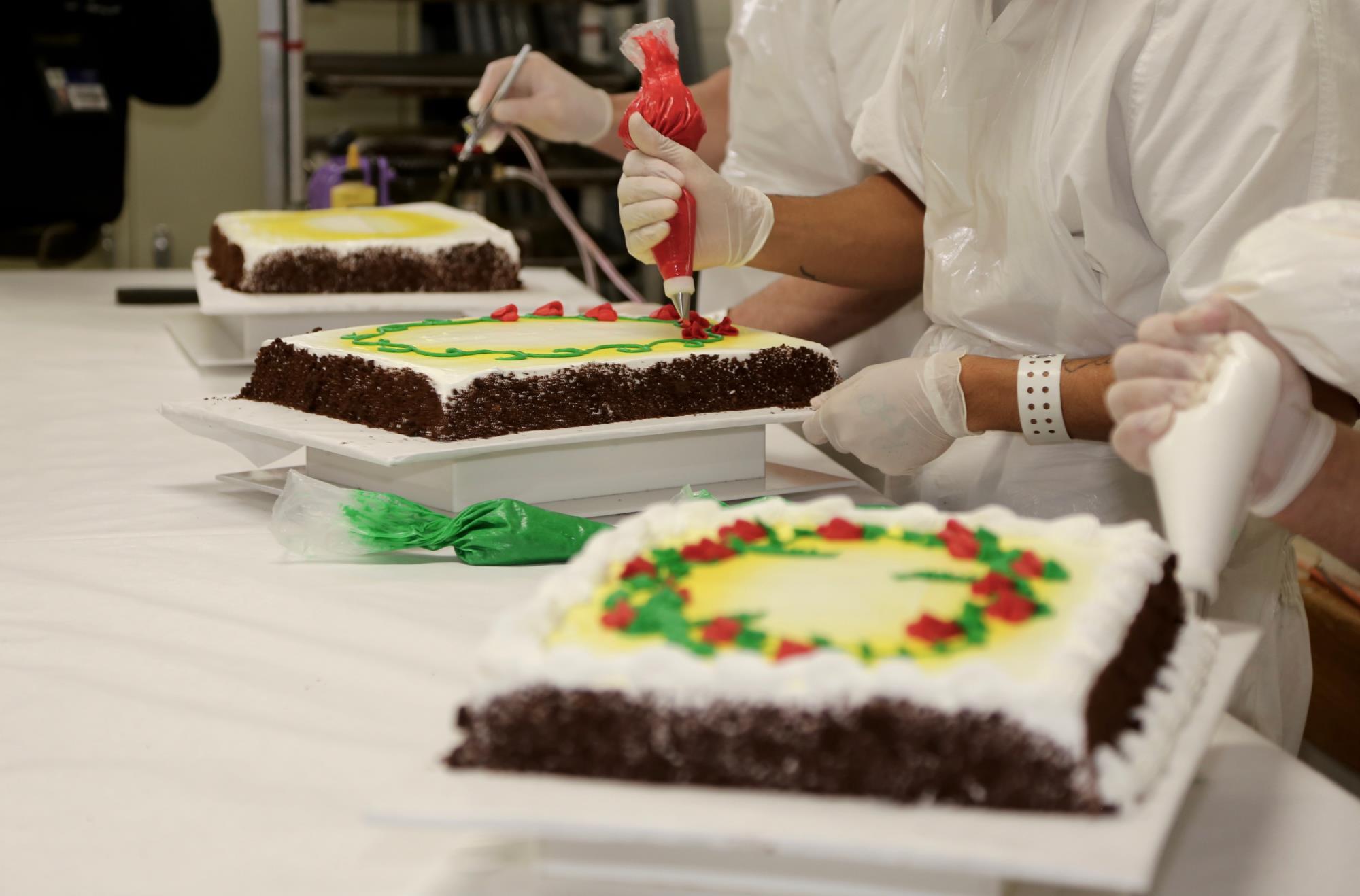 Bakery students at East Mesa decorating a cake