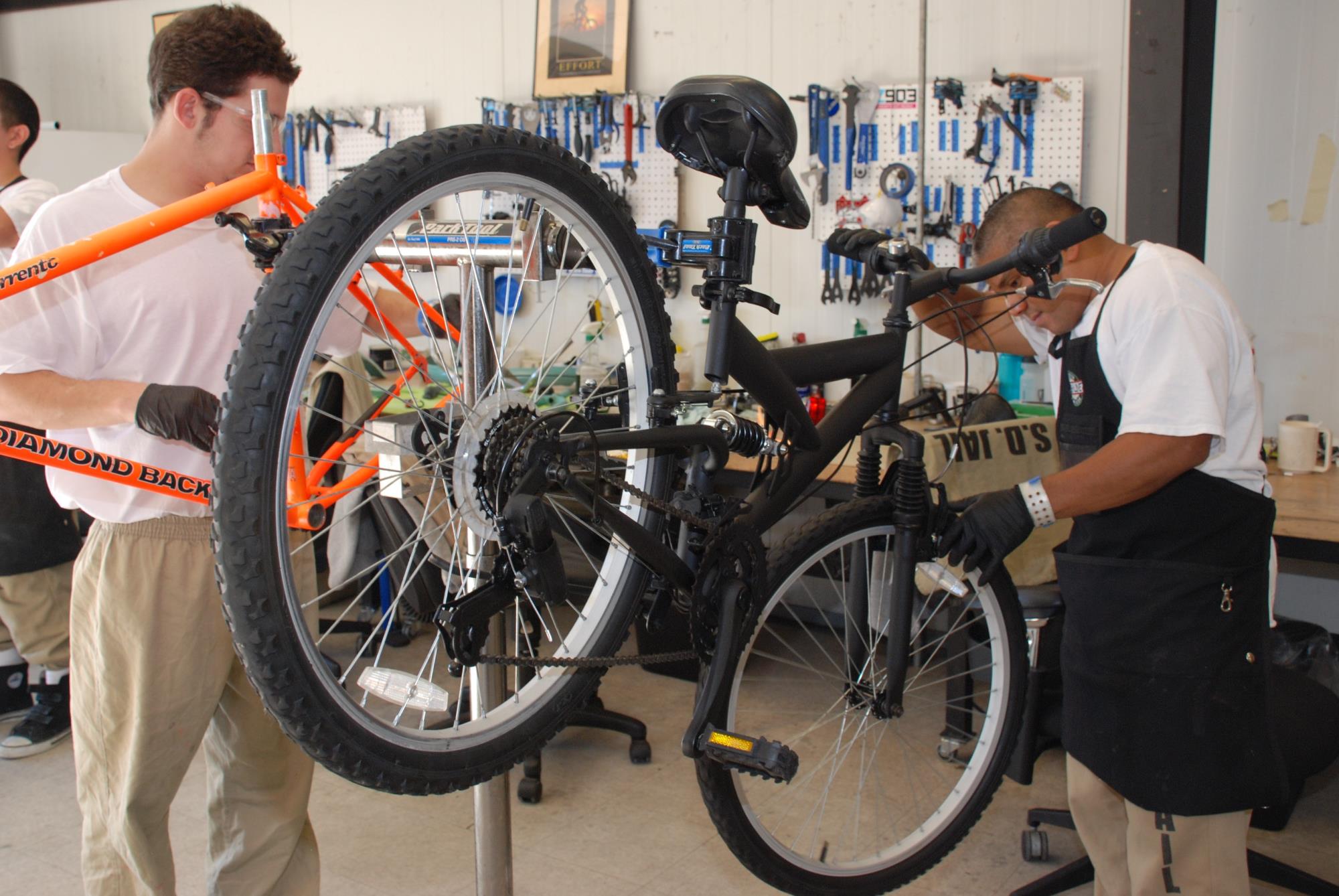 2 Bicycle Program students fixing a bike
