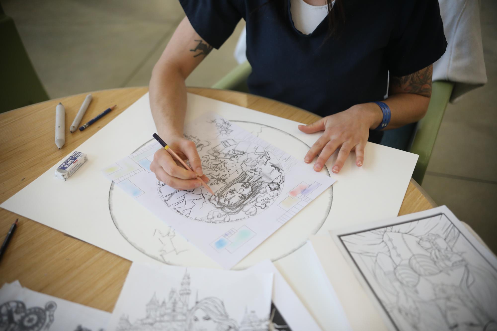 Student drawing a picture in art class