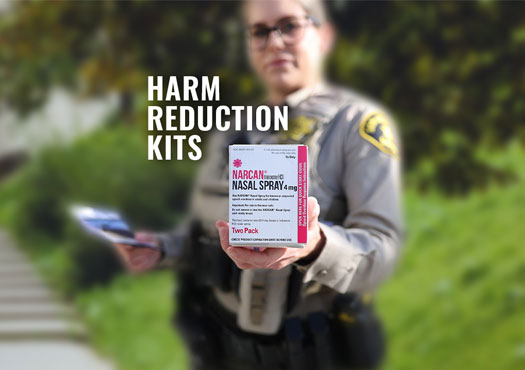 Deputy holding a Harm Reduction Kit